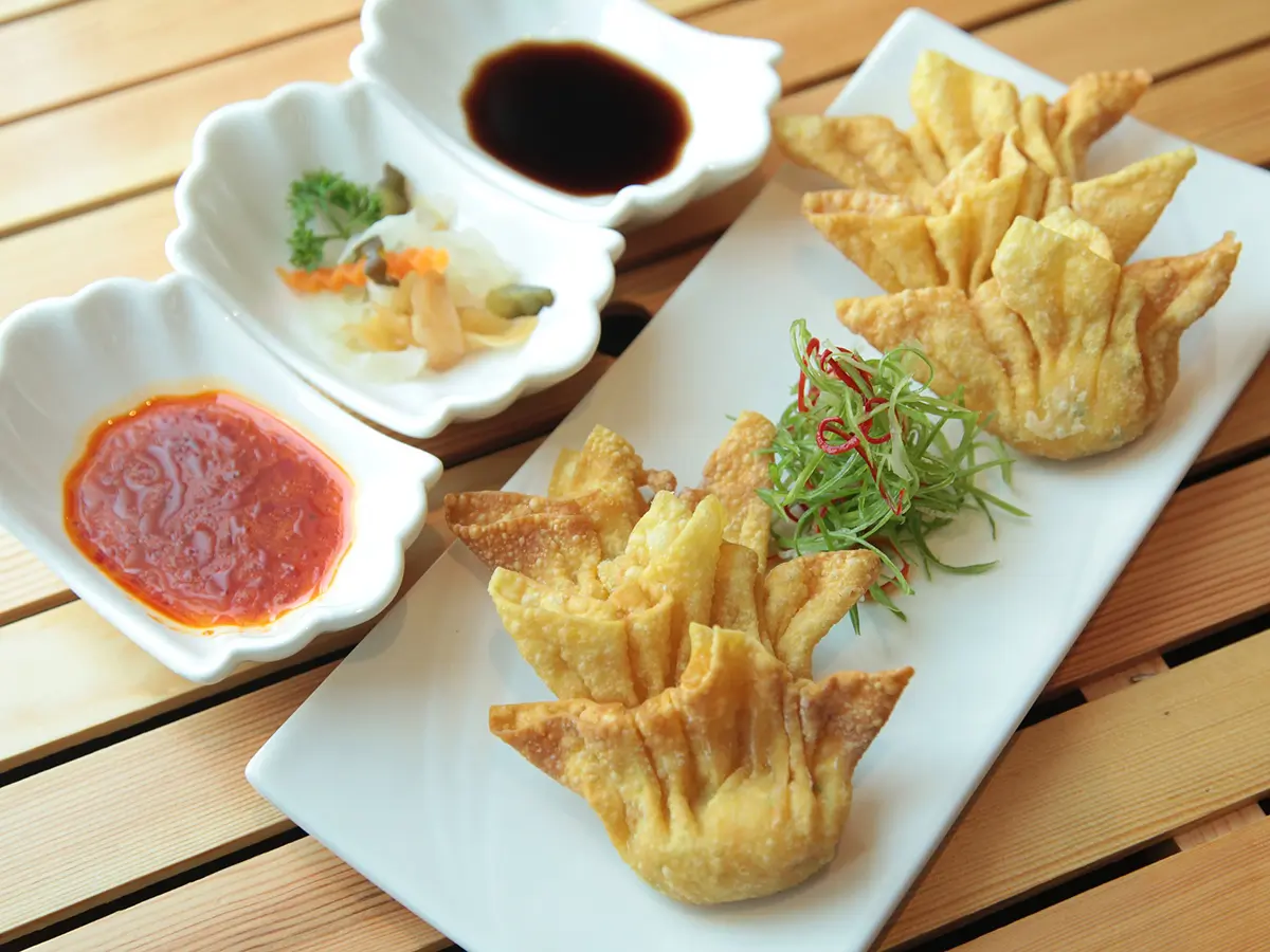 Fried wontons served with dipping sauces and pickles at Hong Yun Chinese Restaurant in Bayville
