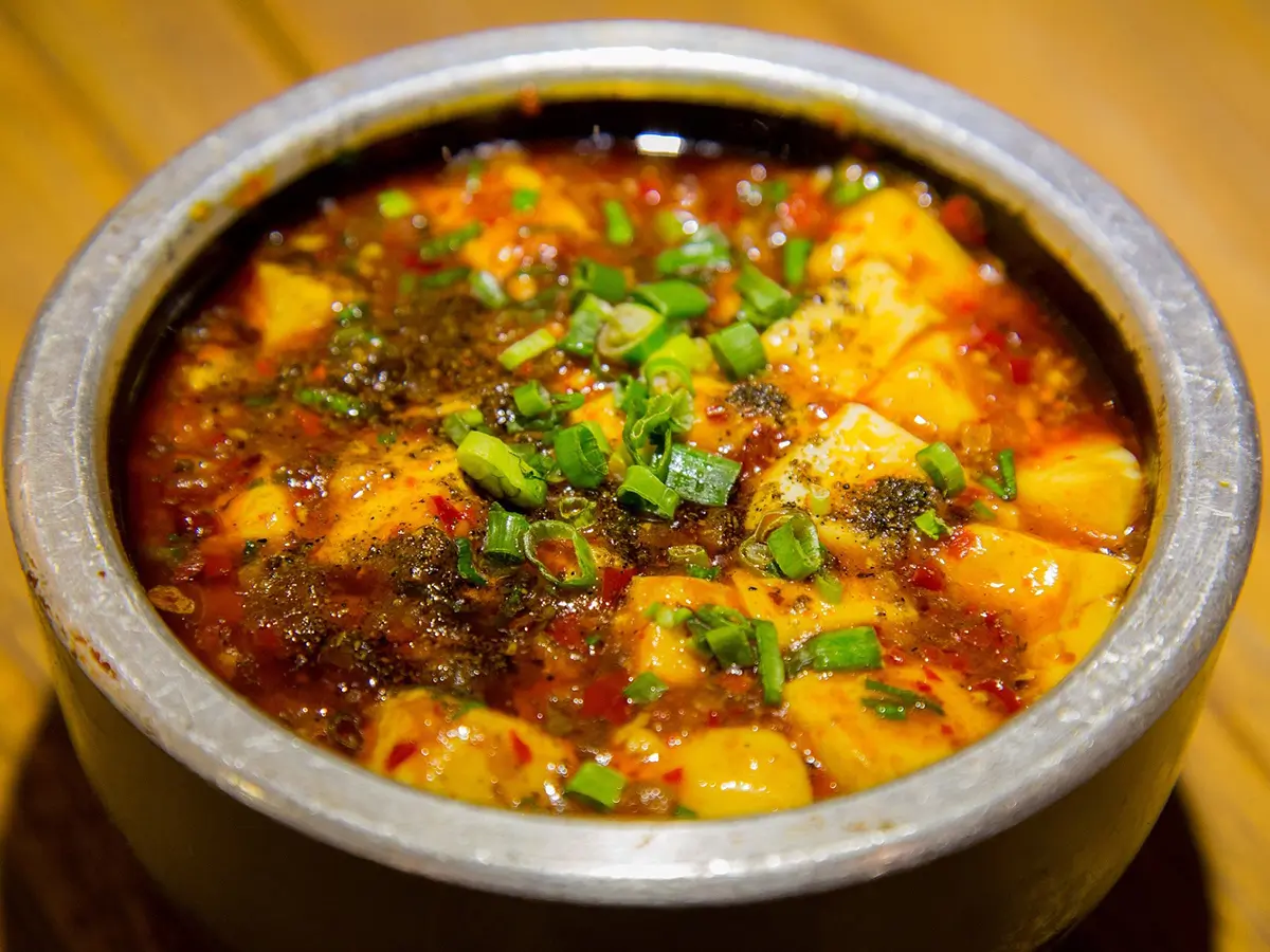 Spicy Mapo tofu with green onions in savory sauce at Hong Yun Chinese Restaurant in Bayville